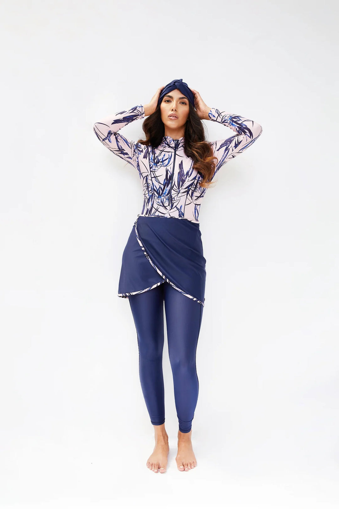 Model wearing sofia tropical pink print in navy blue and baby pink with leggings and turban