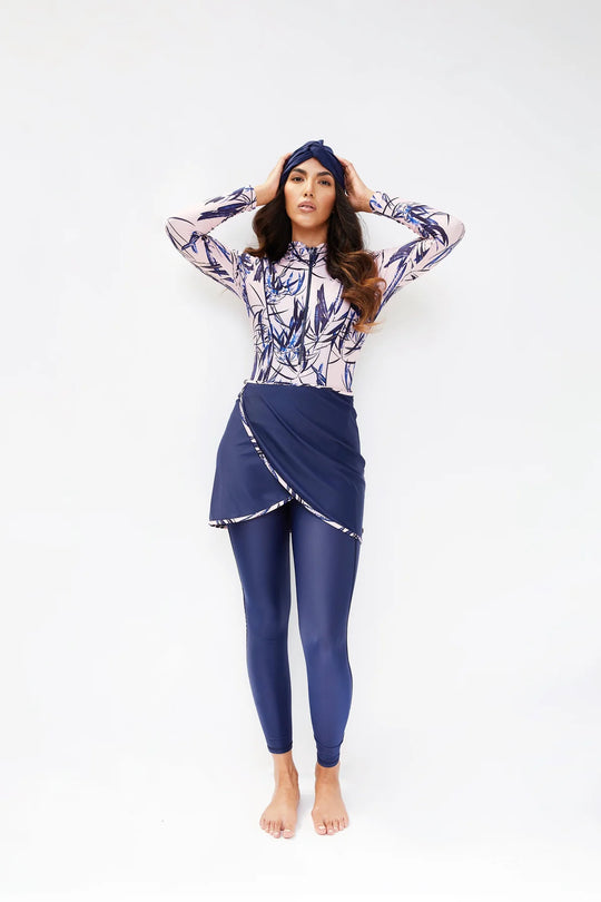 Model wearing sofia tropical pink print in navy blue and baby pink with leggings and turban