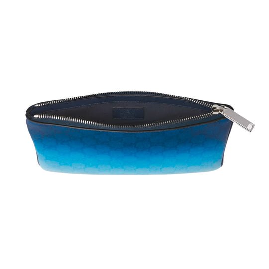 An overhead view of an open blue Gucci pouch, revealing its dark blue interior and the gradient effect of the exterior, transitioning from dark to light blue with the GG monogram pattern.