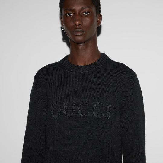 Close up view of model wearing Gucci cashmere sweater with intarsia