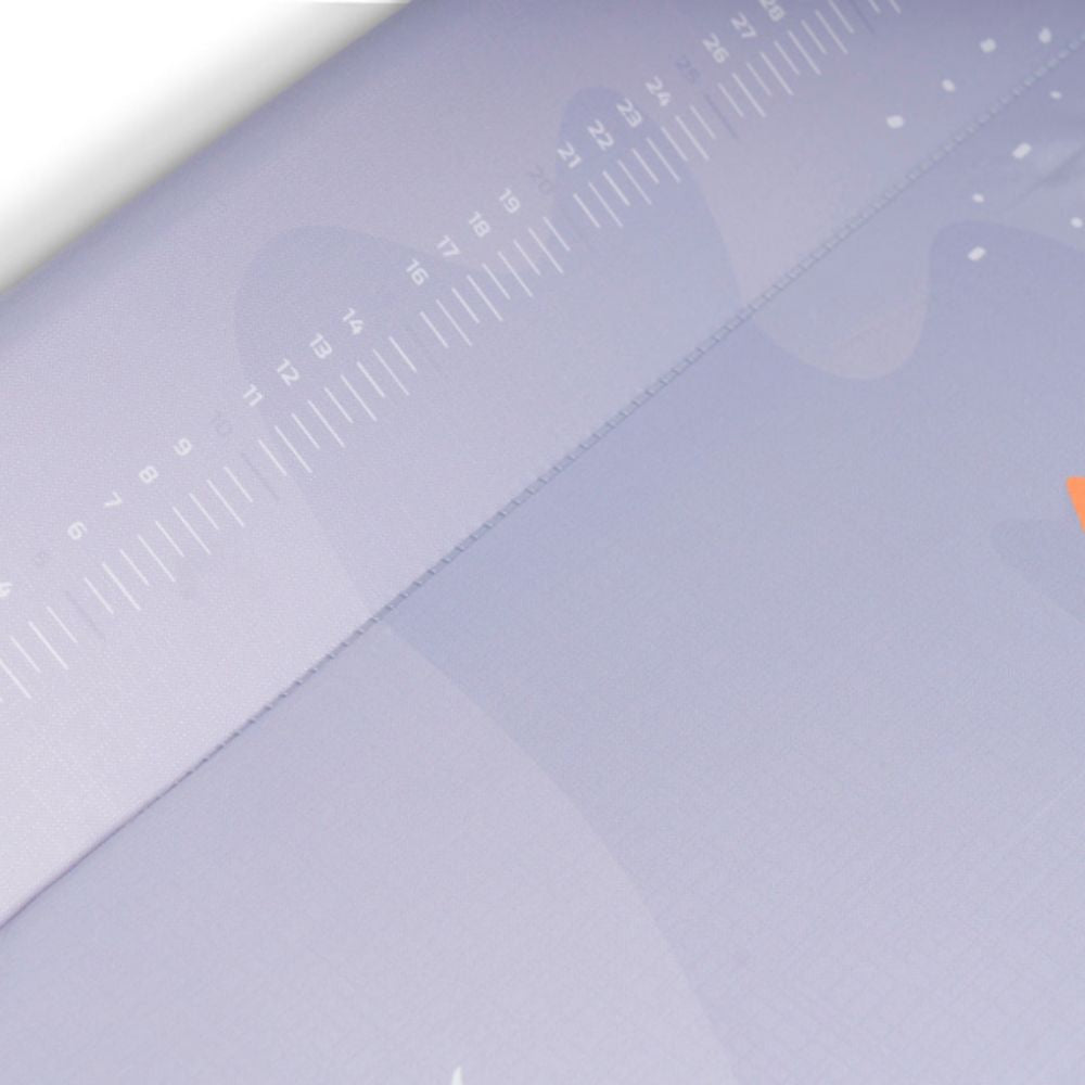 Close-up of a light purple surface with text and design elements.