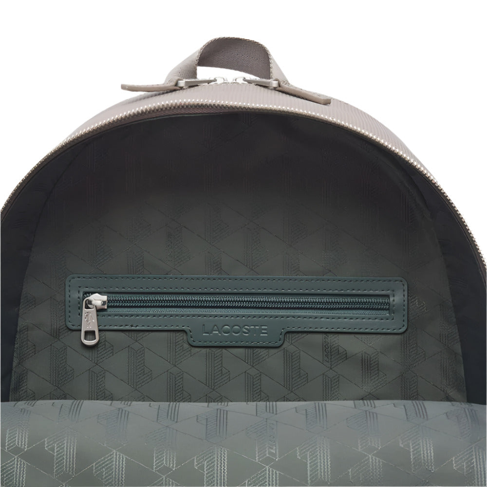 A close-up shot of the open main compartment of a LACOSTE Chantaco Pique Leather Brown Backpack
