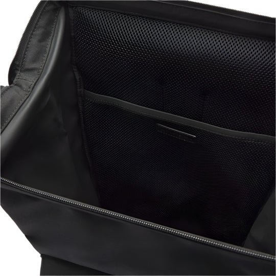 A close-up view inside an open black backpack reveals a zippered main compartment, a mesh pocket, and a flat inner pocket.