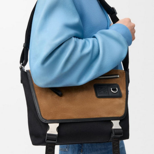 Side View of a Person holding a LOEWE Black/Dark Gold Medium Flex Messenger Bag in Canvas & Suede 