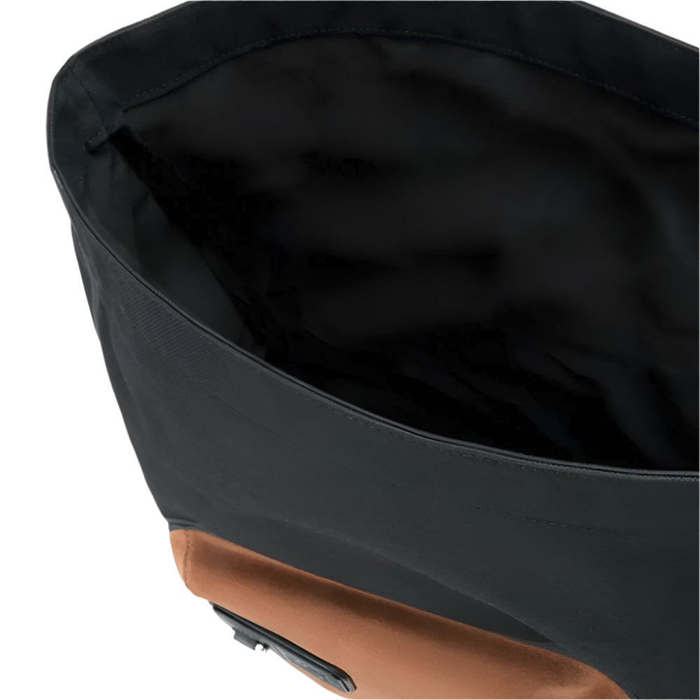 A close-up view of the open top of a LOEWE Flex Roll-Top Backpack, showing its black canvas exterior and the black water-resistant nylon lining of the spacious main compartment. 