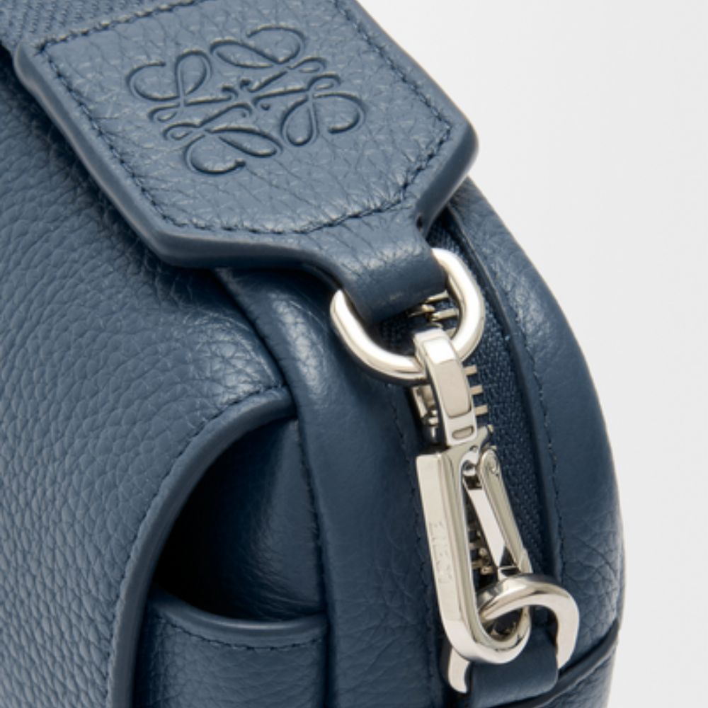 Close-up of a LOEWE Small Pebble Messenger Bag in Supple Grained Calfskin with a silver zipper and brand logo.