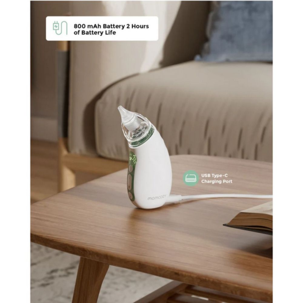 Momcozy Quiet Rechargeable Baby Nasal Aspirator on a wooden table, with text about battery life and charging port.