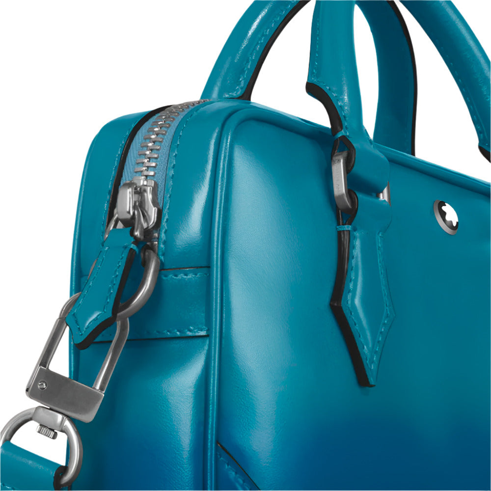 Close-up of Montblanc Meisterstück Sfumato Blue Leather Mini Document Case with a silver zipper and handle on a light gray background
