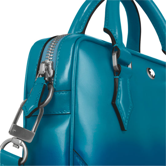 Close-up of Montblanc Meisterstück Sfumato Blue Leather Mini Document Case with a silver zipper and handle on a light gray background