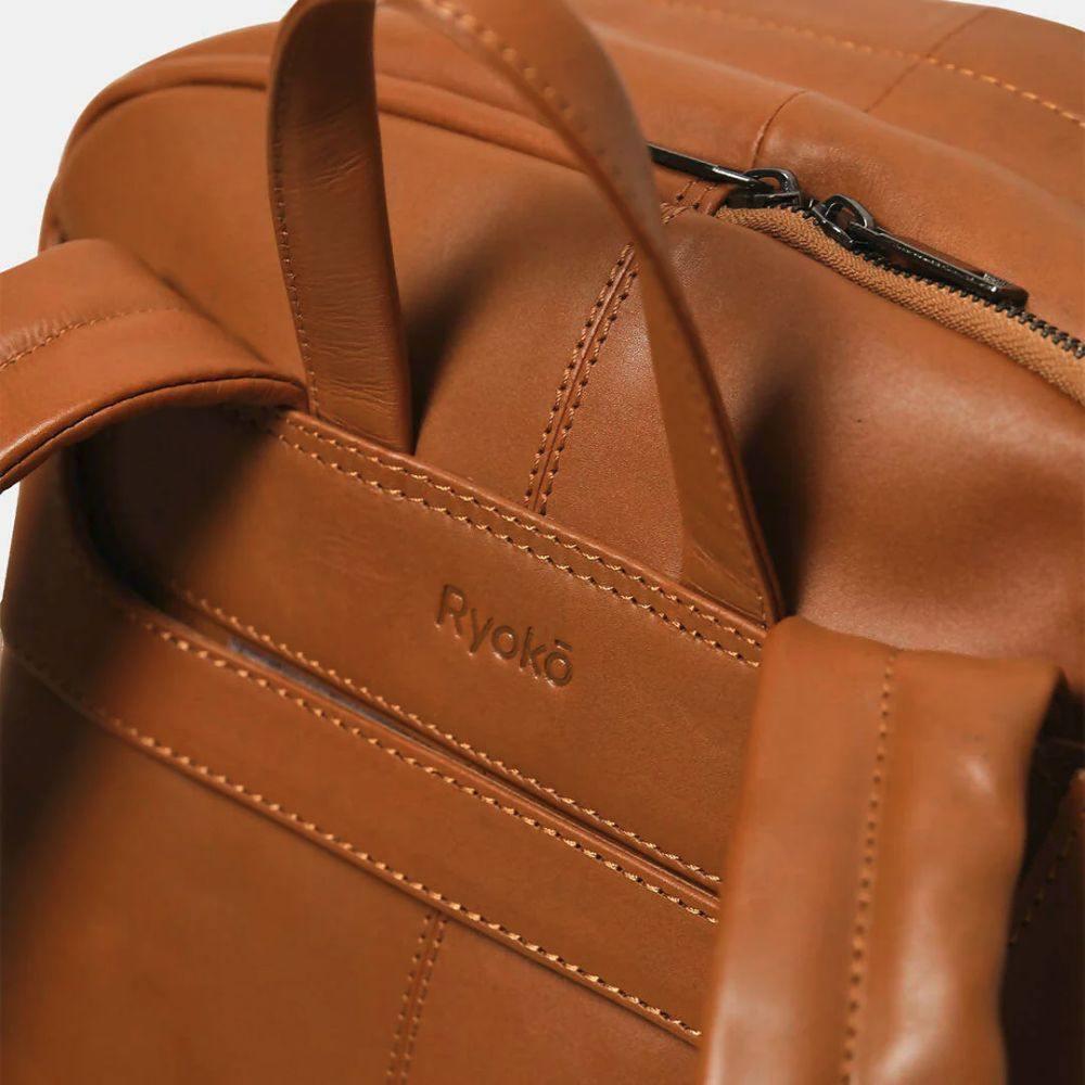 Close-up of a brown leather bag with 'Ryoko' branding.
