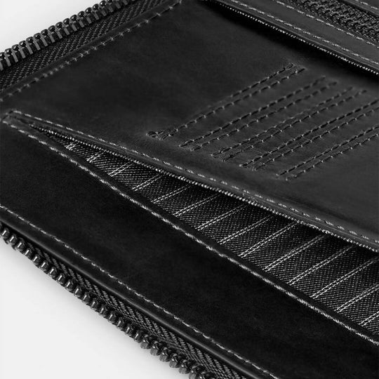 Close-up of black fabric with a textured pattern on a white background