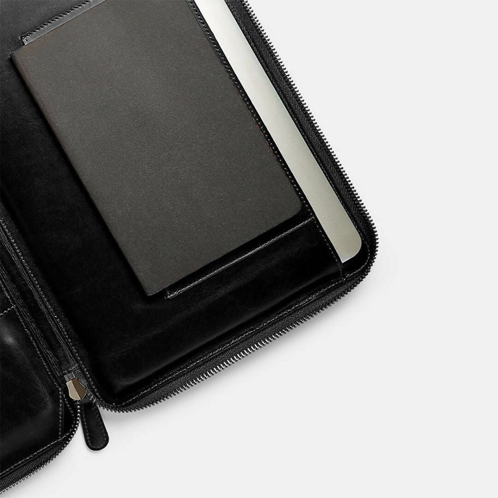 Black leather case with a tablet inside on a white background