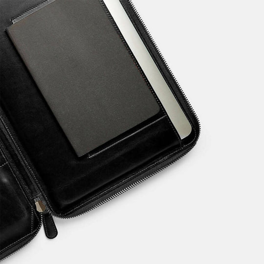 Black leather case with a tablet inside on a white background