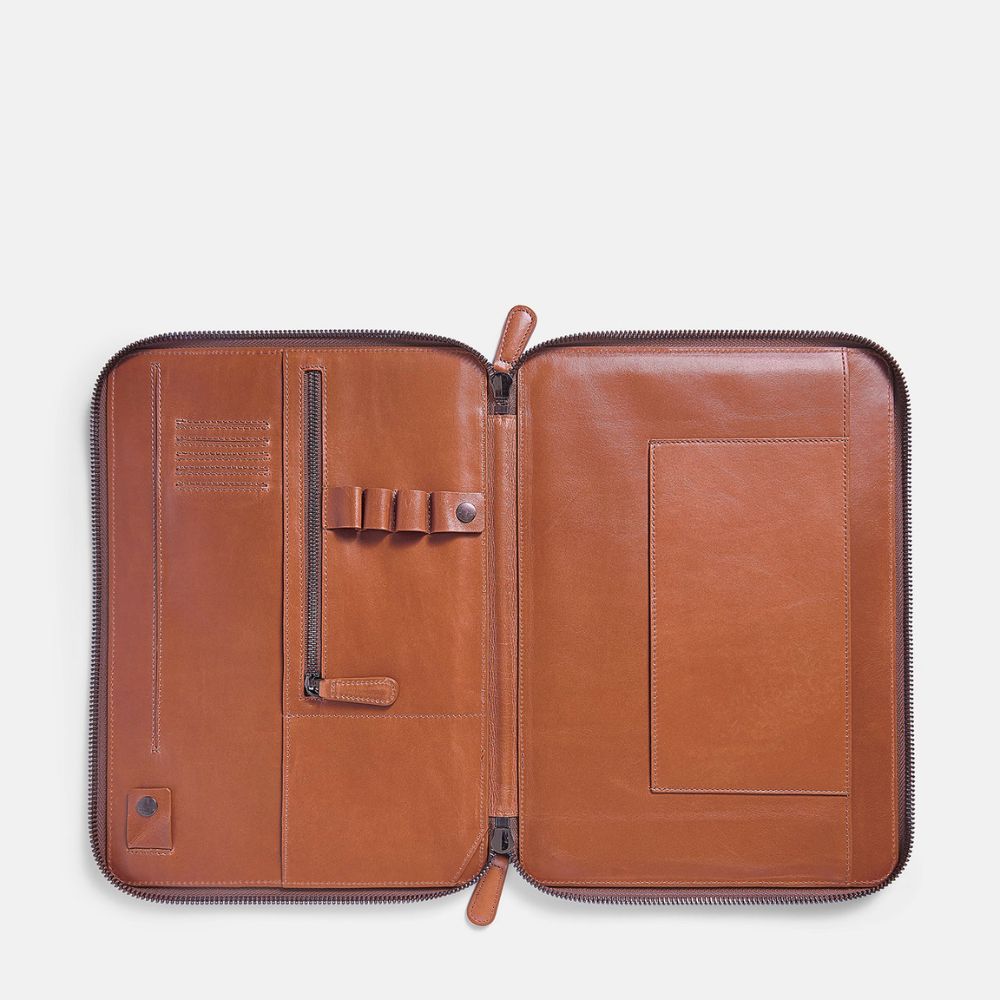 Caramel colored leather portfolio with zipper on a white background