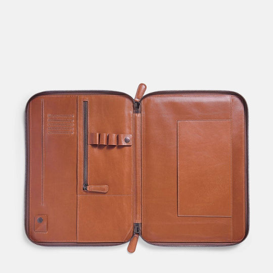 Caramel colored leather portfolio with zipper on a white background