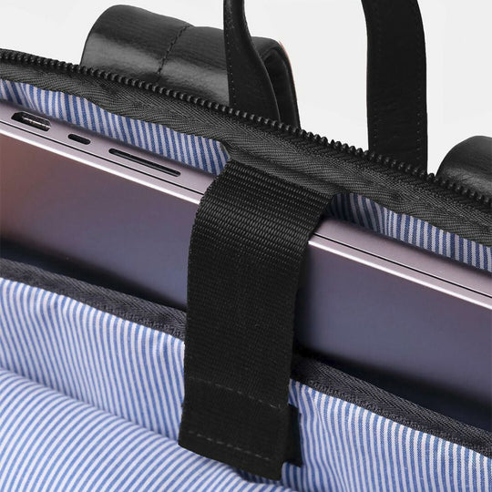 Close-up of a laptop in a protective case with blue and white striped lining.