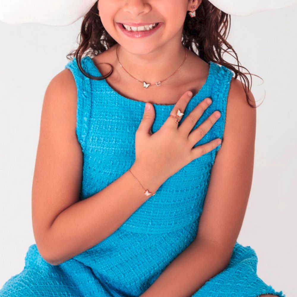 A kid showing Samra Classic Butterfly Rose Gold Mother of Pearl Kids Ring on her hand