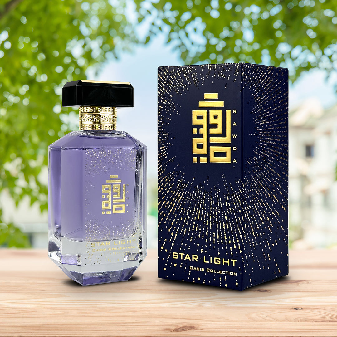 An EDP 100mL spray bottle of Starlight perfume by Rawda along with the Box with a beautiful background of a tree