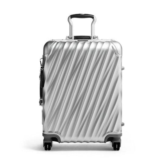 Silver suitcase with black handle and wheels on a white background