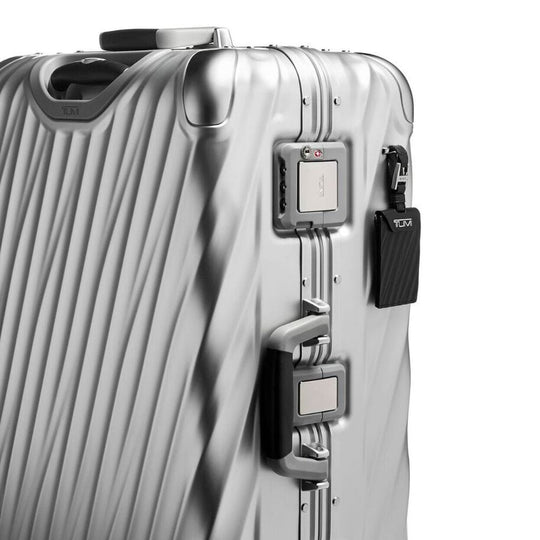 Close up view of the the combination lock and handle on TUMI Iconic 19 Degree Silver Aluminum Packing Case With TSA Locks And Recessed Wheels: Model 98821-1776