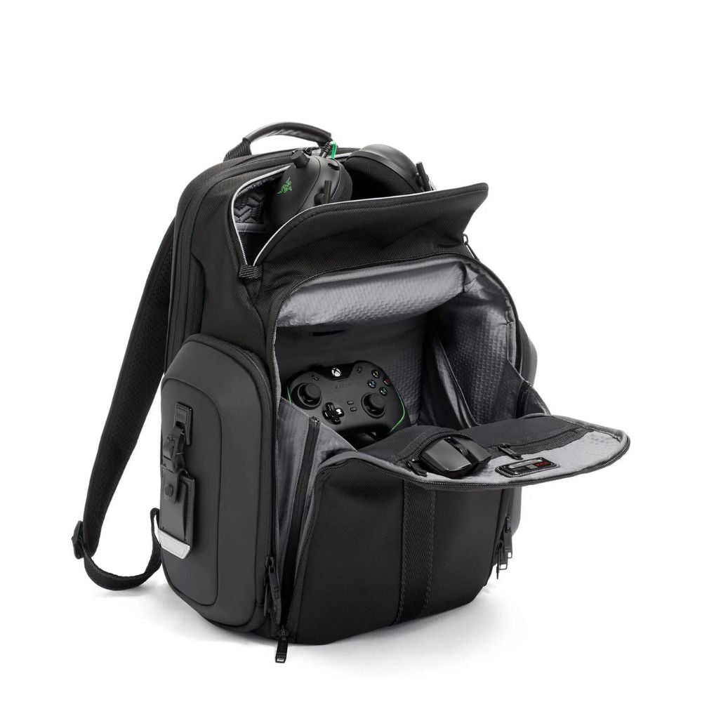 Black backpack with gaming console and accessories on a white background