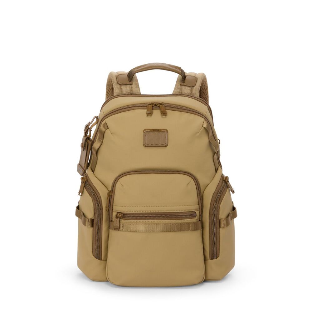 Tan backpack with multiple pockets and straps on a white background
