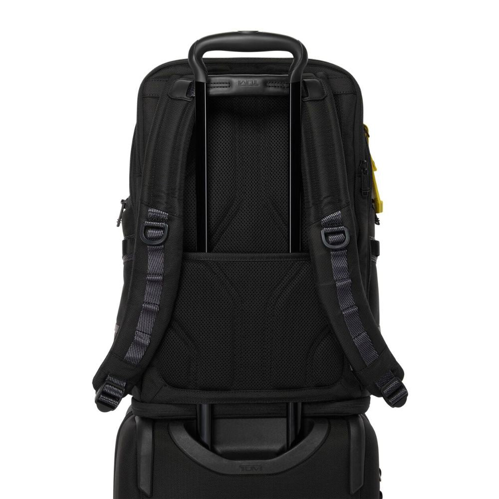  Rear view of TUMI Alpha Bravo Nomadic Backpack, Model 159071-A867, kept on top of a Carry on luggage