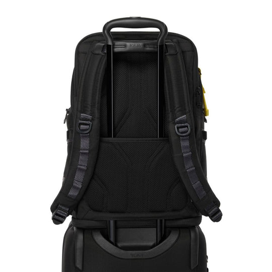  Rear view of TUMI Alpha Bravo Nomadic Backpack, Model 159071-A867, kept on top of a Carry on luggage