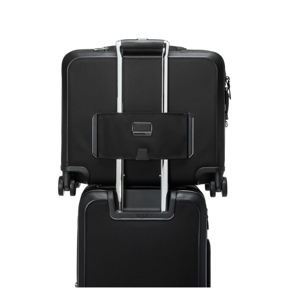 Black suitcase with a attached black pouch on a white background