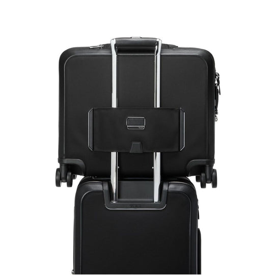 Black suitcase with a attached black pouch on a white background