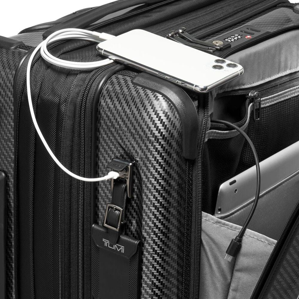 Black suitcase with a phone and cable attached, featuring TUMI branding.