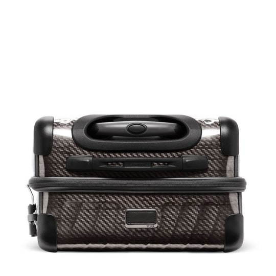 Carbon fiber patterned suitcase with black handle on a white background