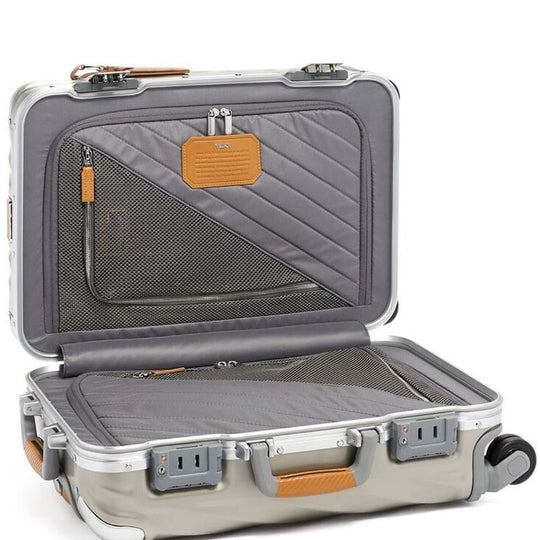 Open gray suitcase with interior details on a white background