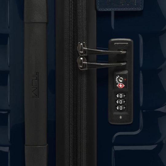 Close-up of a suitcase handle and lock mechanism on navy blue color TUMI 19 Degree Expandable Case