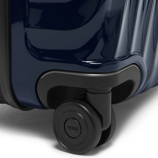 Close-up of the wheel on the navy blue color TUMI 19 Degree Expandable Case
