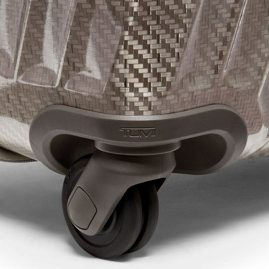 Close-up of a suitcase wheel with a textured surface on a white background