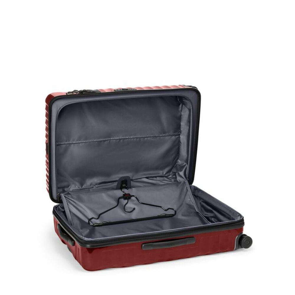 Open red suitcase with black interior on a white background