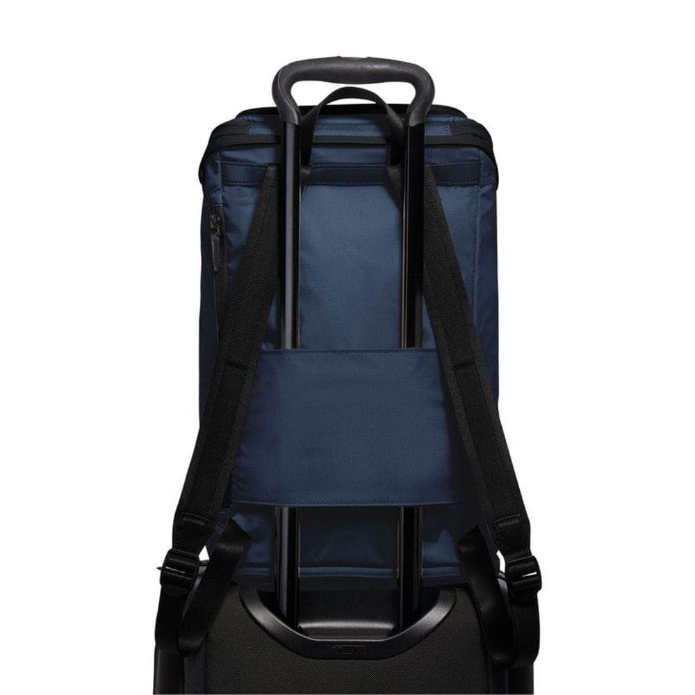 Back view of a navy blue backpack with black straps on a white background