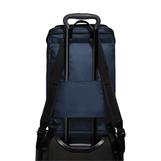 Back view of a navy blue backpack with black straps on a white background