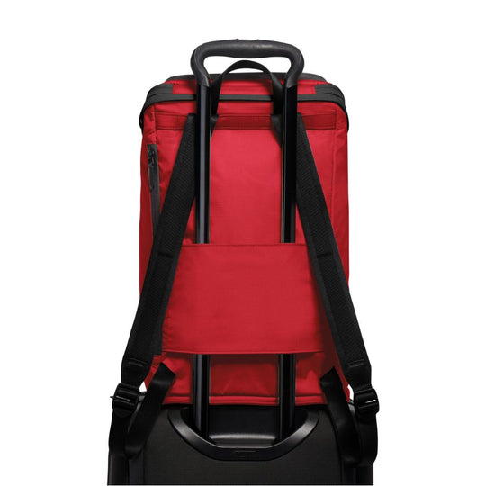 Red backpack with black straps on a white background