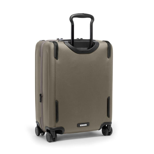 Beige suitcase with black handle and wheels on a white background