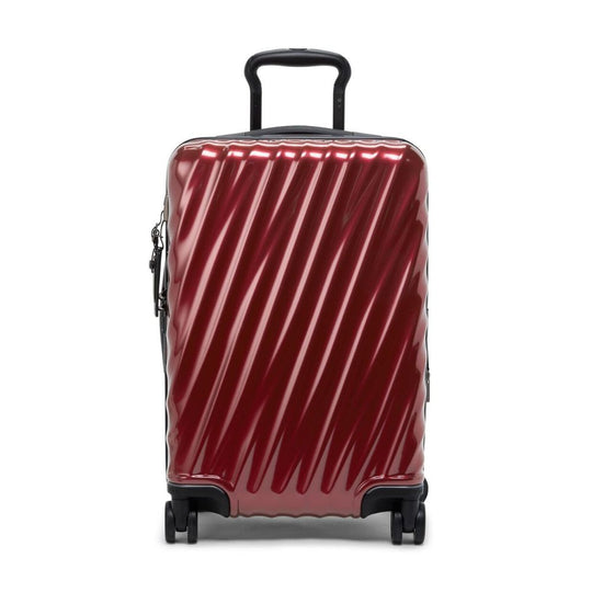 Red suitcase with black handle and wheels on a white background