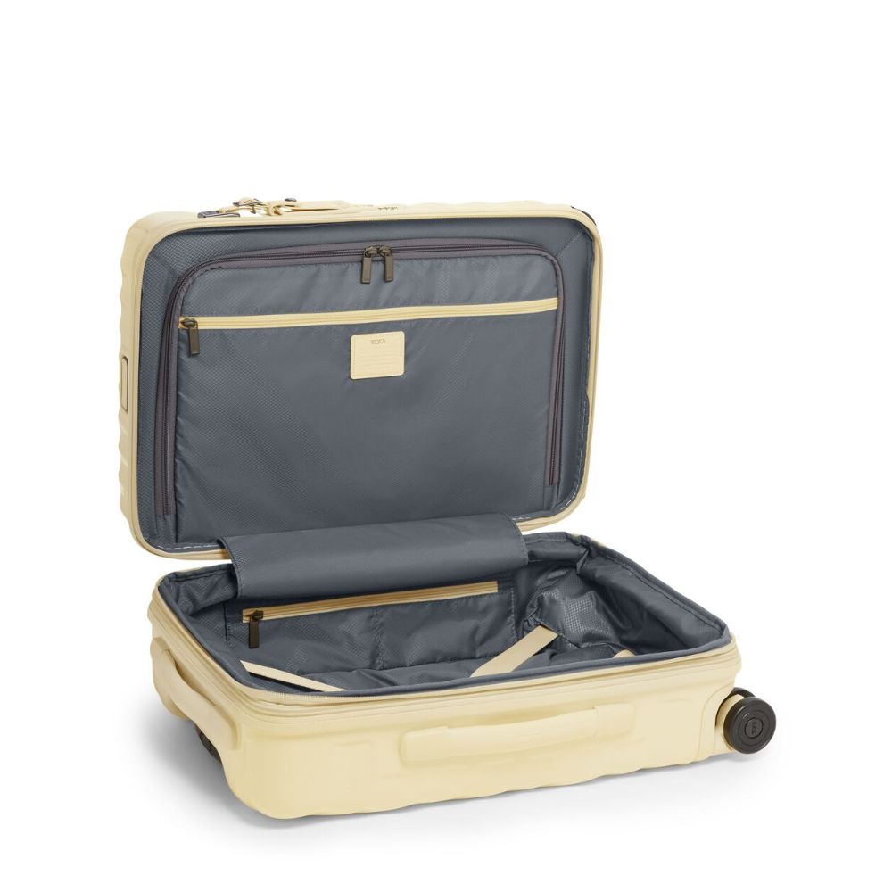 Beige suitcase with open lid on a white background