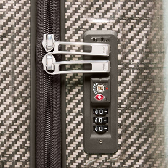 Close-up of a Tumi suitcase with a textured surface and zipper details.