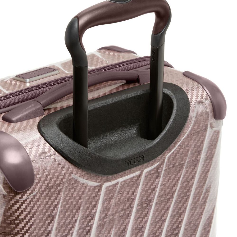 Close-up of a suitcase handle on a textured surface