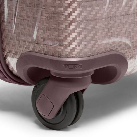 Close-up of a TUMI suitcase wheel on a light gray background