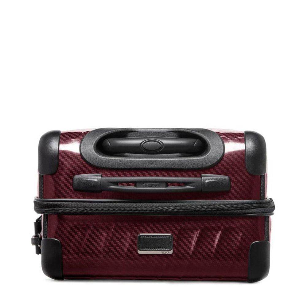 Red suitcase with black handle and wheels on a white background
