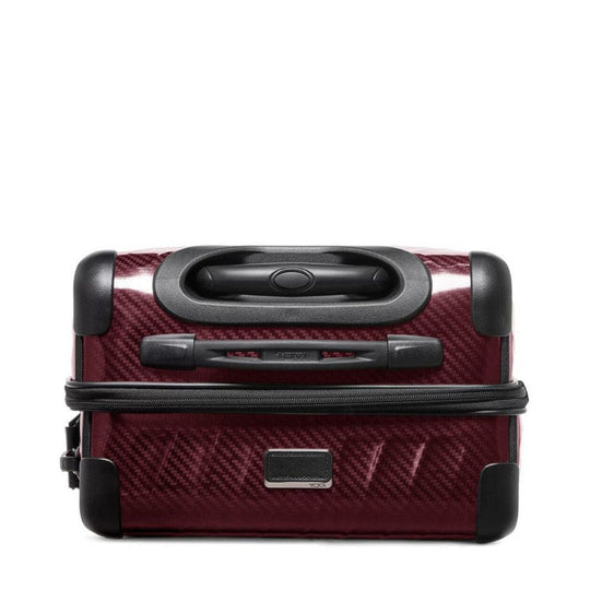 Red suitcase with black handle and wheels on a white background