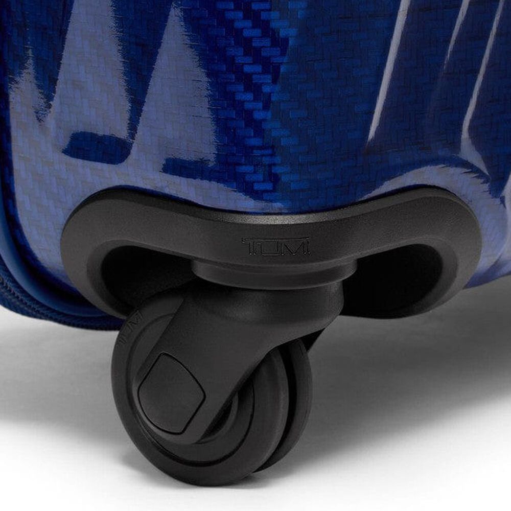 Close-up of a blue suitcase with a black wheel on a white background