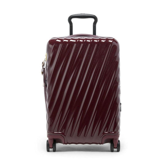 Maroon suitcase with diagonal stripes on a white background